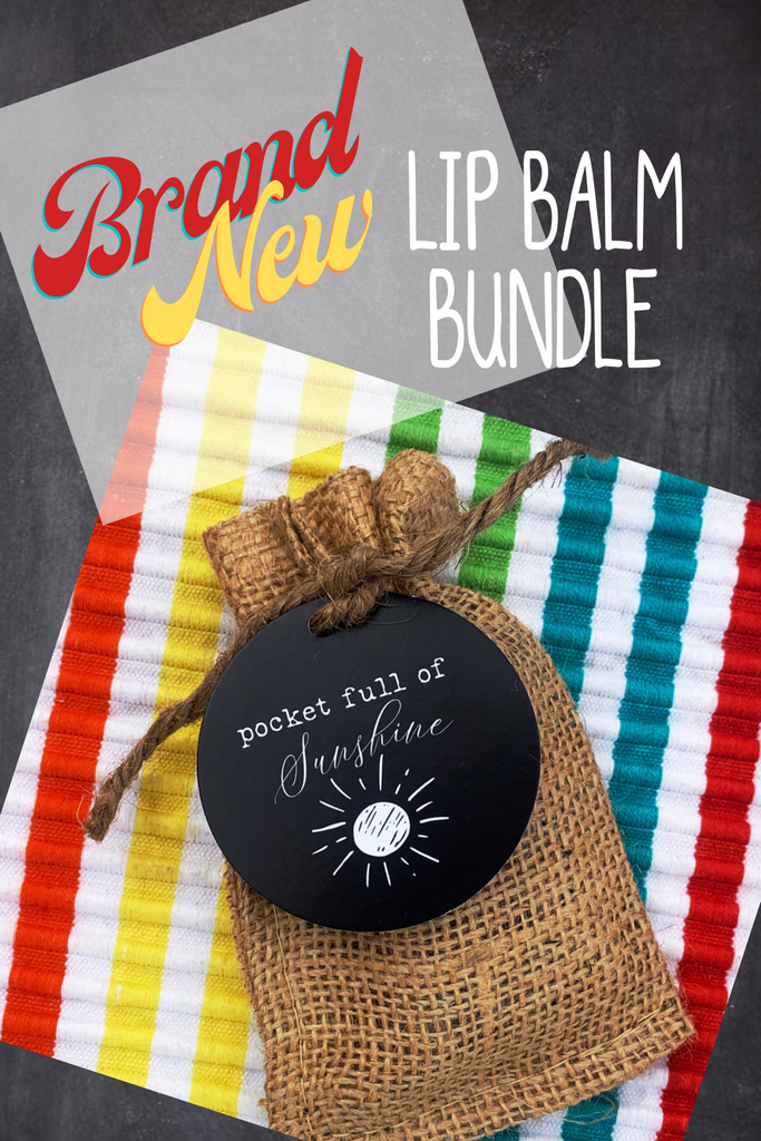 A burlap bag containing three lip balms on a rainbow striped piece of fabric with bold text that says "Brand New Lip Balm Bundle"